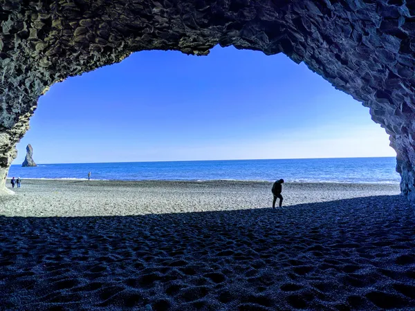 Peeking Out the Cavern on the Icelandic Coast thumbnail