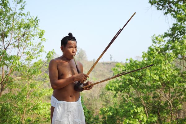 An indigenous Mro tribal man play flute thumbnail