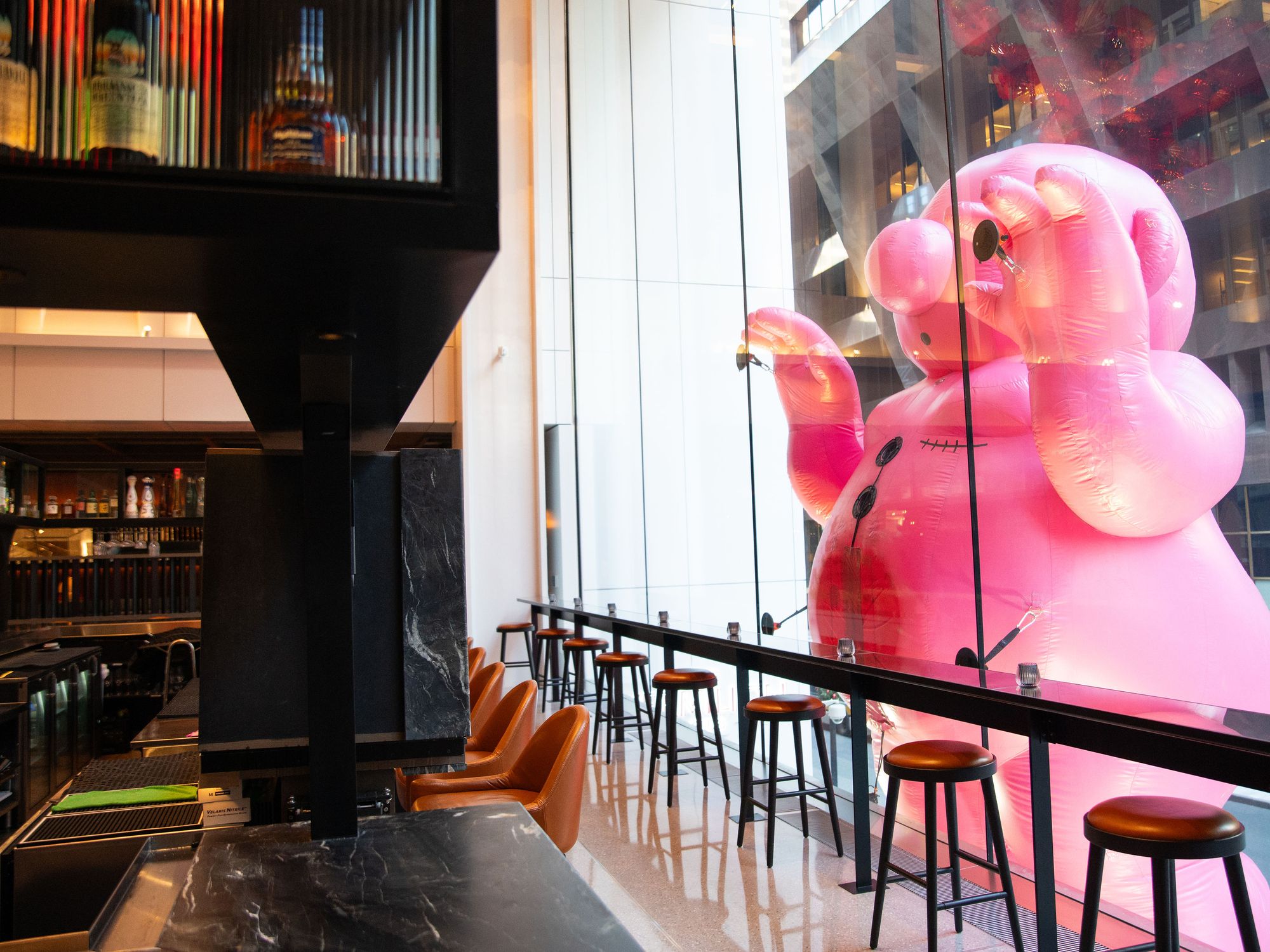 These Massive Inflatable Pink Men Are Waving From Rooftops and Peering ...