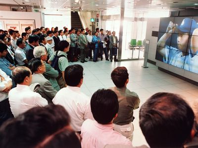 Tokyoites watch Hideo Nomo pitch for the Los Angeles Dodgers at Sony Plaza on June 30, 1995.