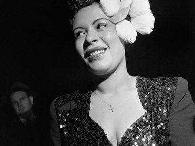 Jazz singer Billie Holiday wears a large white flower in her hair for a performance in New York City.