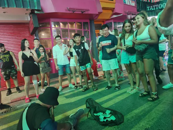 A musician plays on Bangla Road for tourists thumbnail