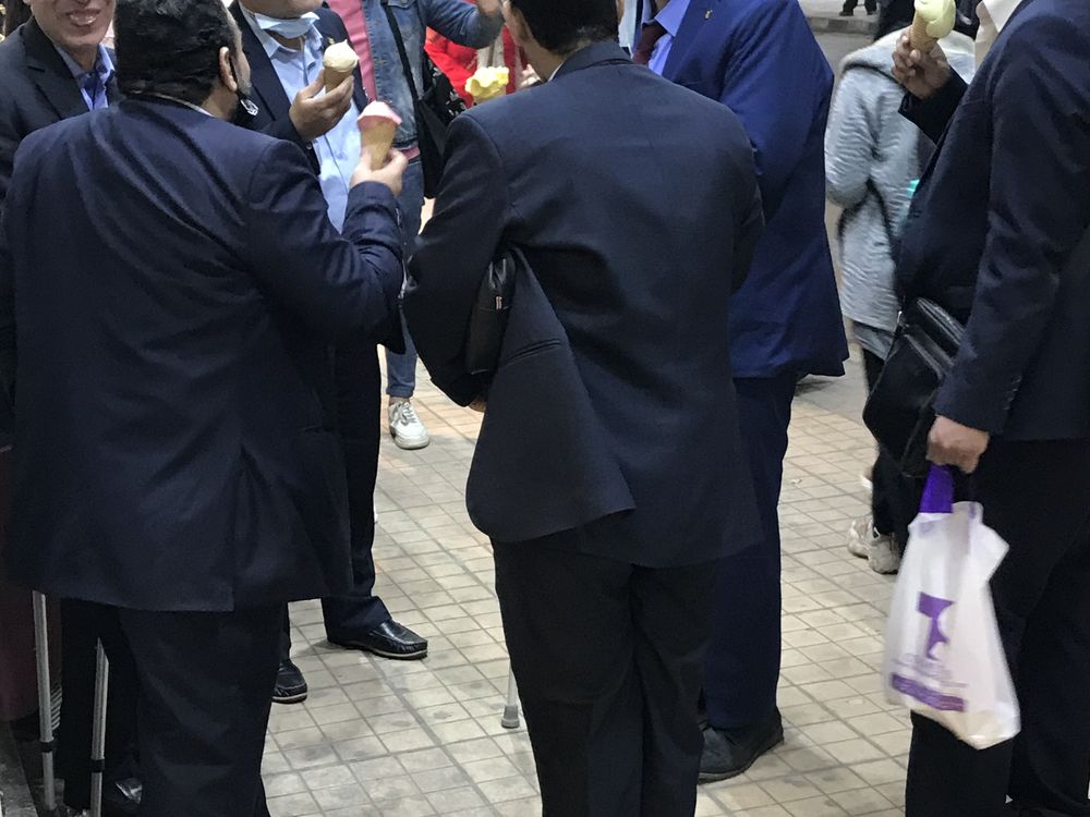 Men in suits are on break enjoying ice creams Smithsonian Photo