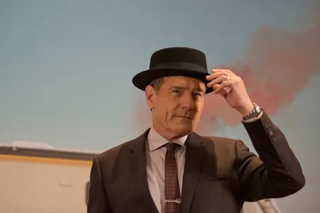 Actor Bryan Cranston impulsively modeled the Heisenberg hat—now a museum artifact—while nervous curators looked on.