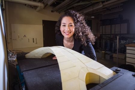 Karly Bast with her scale model of Leonardo da Vinci's bridge design