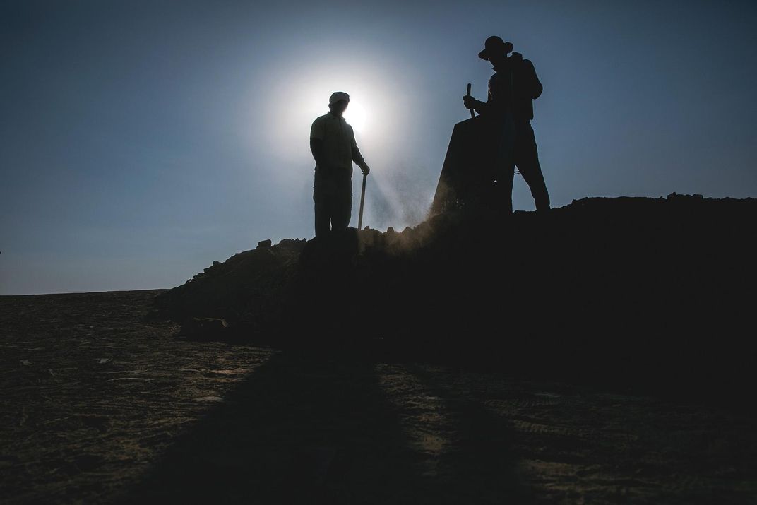 two figures at dig site