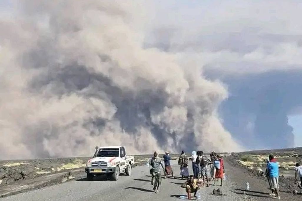 a volcanic plume seen over a road
