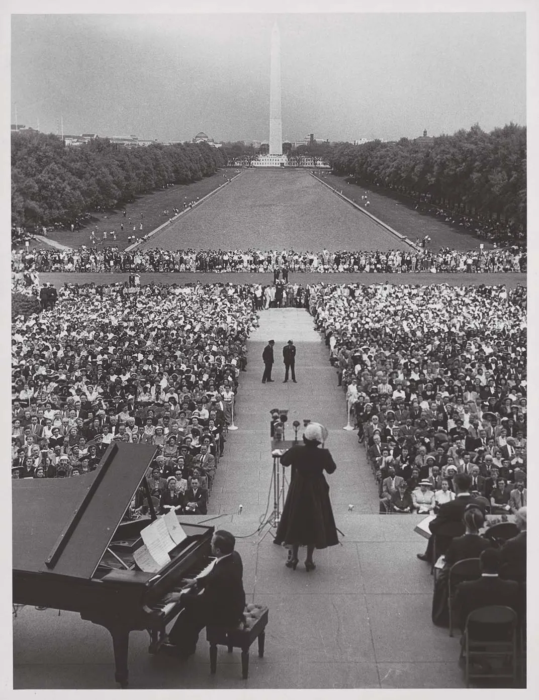 a women sings to a large audience on the National Mall