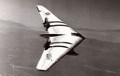 A Northrop YB-49 in flight over desert, probably in the vicinity of Muroc, California.