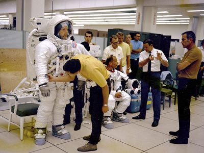 Apollo 11 astronauts Neil Armstrong (L) and Buzz Aldrin prepare for an EVA training session, watched by Deke Slayton (R) in this undated handout photo courtesy of NASA.