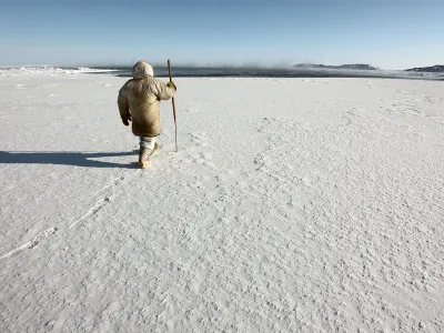 Hunters, trappers and other land users in the North are using Siku, a mobile app named after the Inuktitut word for &ldquo;sea ice,&rdquo; to share environmental information, including ice conditions. Here, an Inuit hunter prepares to test the safety of sea ice near Sanikiluaq, Nunavut, with a harpoon.