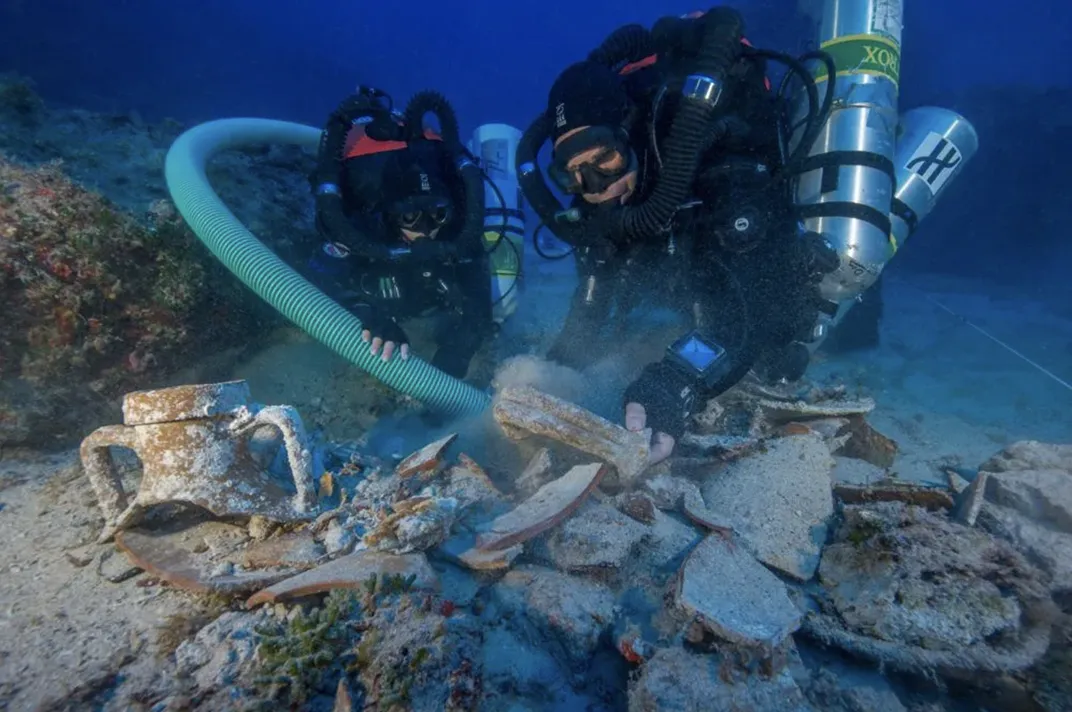 Divers examine objects from the Antikythera shipwreck