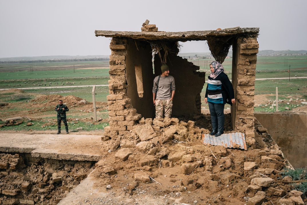 Archaeologist Layla Salih talks with a member of a local Christian militia tasked with protecting the city of Nimrud.