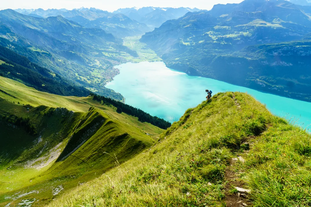 A runner moves along a ridge-top trail