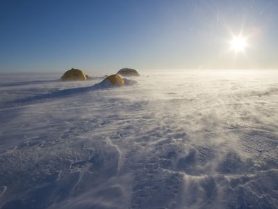 The interior of Greenland (seen here with researchers’ tents pitched) is usually covered in frozen ice and snow. In July 2012, though, 97 percent of the surface melted for the first time in more than 100 years. Scientists now know why that happened.