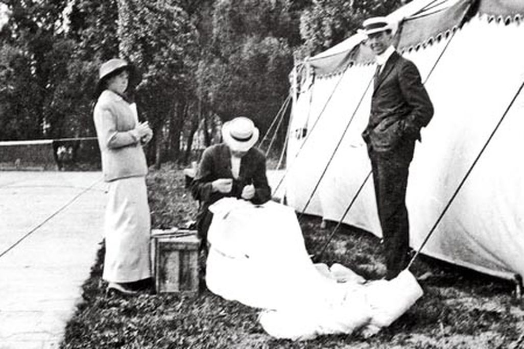 Glenn Martin (standing). By 1913 Martin was taking credit for Broadwick’s invention, and the following year he patented it. Here, he and Tiny watch Broadwick stitch up the canopy of a parachute.