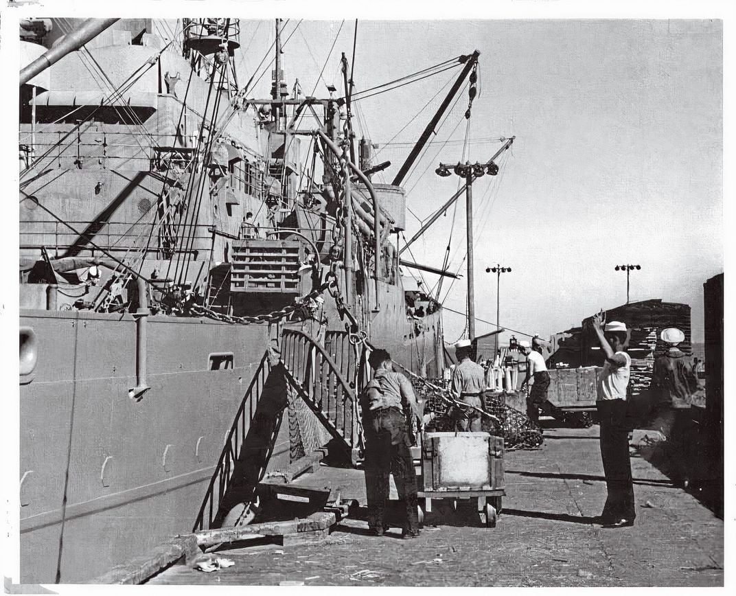 a shipping dock with men loading cargo