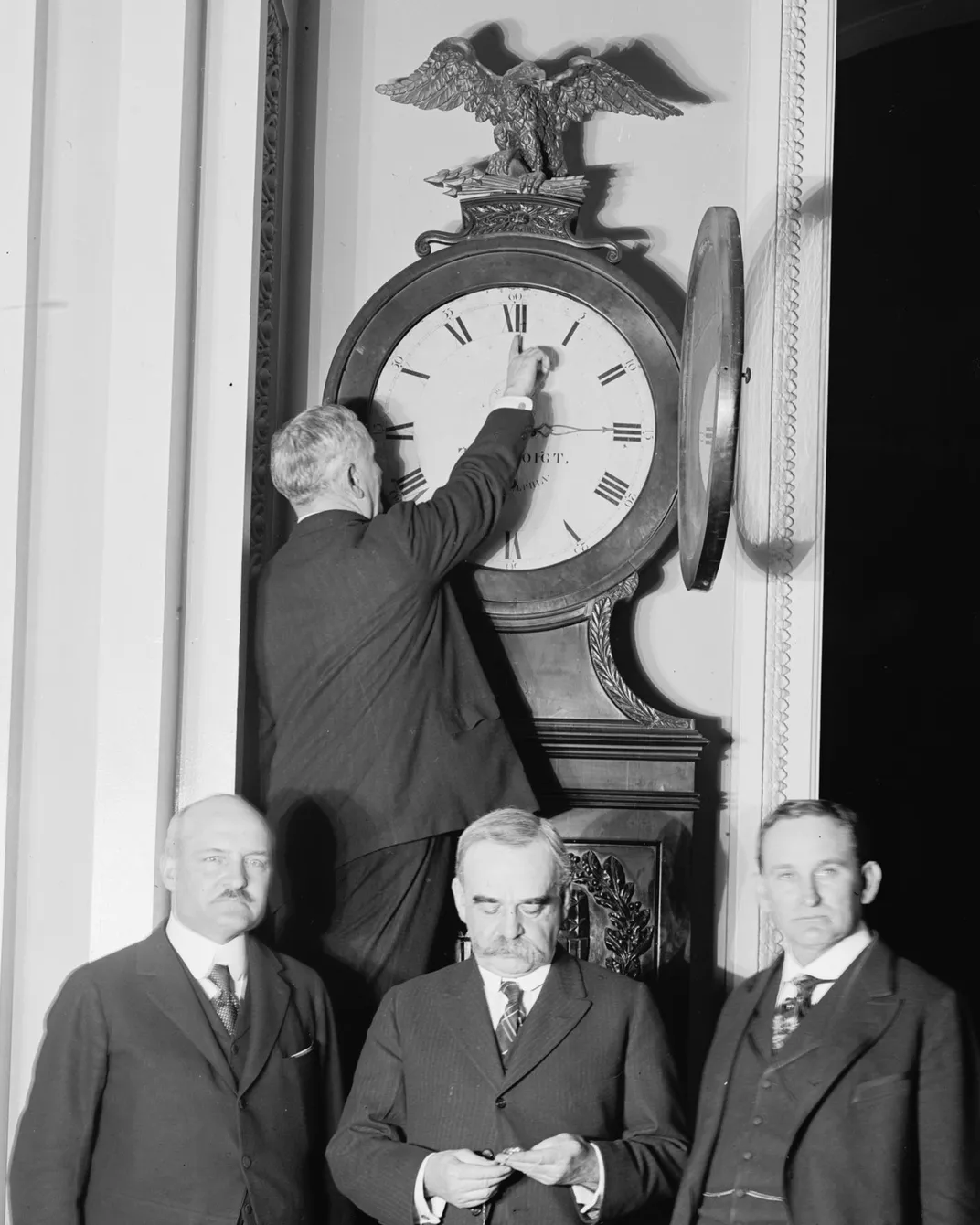 Senate Sergeant at Arms Charles Higgins turns the Ohio Clock in the U.S. Capitol forward for the country's first daylight saving time on March 31, 1918.