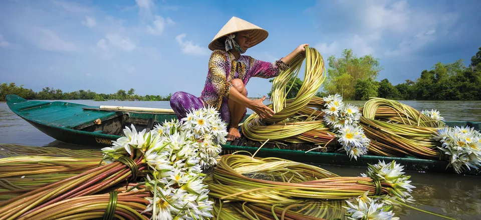  Woman working with flowers on the Mekong. Credit: Nhiem Hoang
