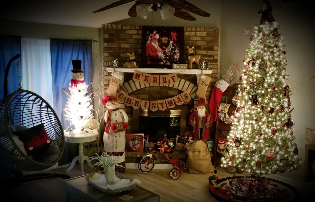 A living room with a Christmas tree and holiday decorations