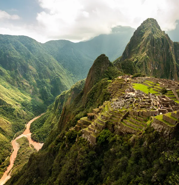 Supporting the Smithsonian Mission (a lifted view of the ruins of MachuPicchu in the verdant mountains beside a brown river)