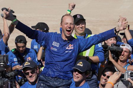 Stanford University Racing Team leader Sebastian Thrun celebrates with his team mates as their entry named "Stanley" is the first to cross the finish line at the Defense Advanced Research Projects Agency (DARPA) 2005 Grand Challenge in Primm, Nevada. 