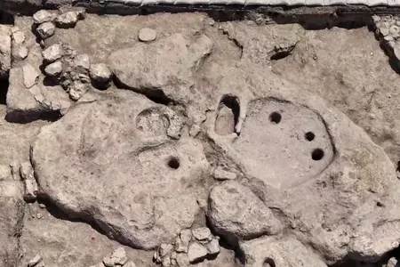 The&nbsp;wine press is composed of a three-holed treading surface (right) and a collection vat (left).