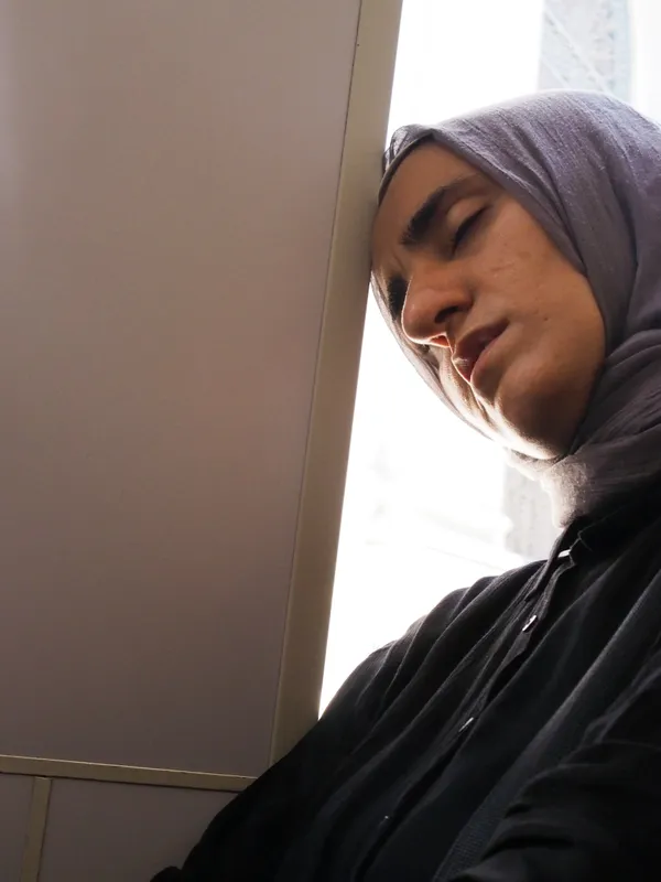 An exhausted woman waiting for a tram in Istanbul thumbnail