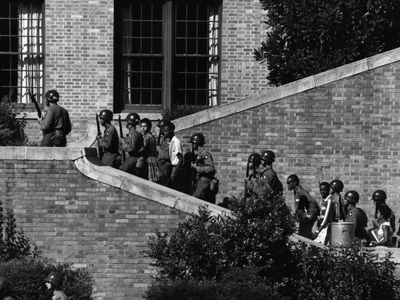 The Little Rock Nine escorted by soldiers from the 101st Airborne Division into Little Rock Central High.