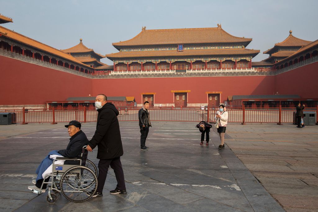 People walk past closed entrance of the Forbidden City in Beijing.