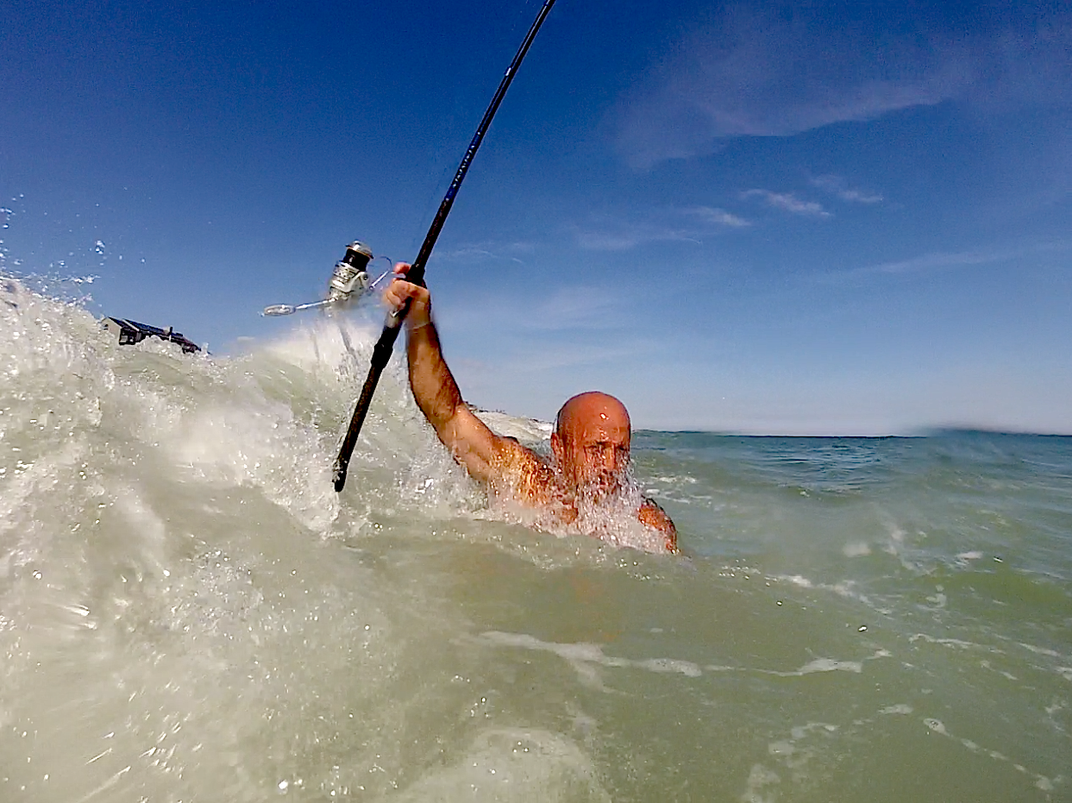 Beach casting to the extreme. This angler fights the surf before