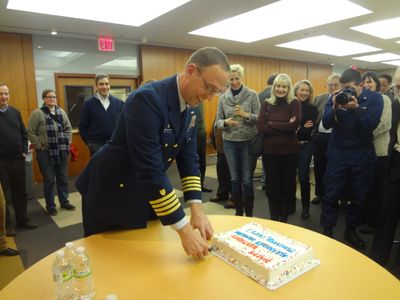 Captain Loebl of the US Coast Guard, Sector New York cuts the birthday cake for Alexander Hamilton at the Museum of American Finance 