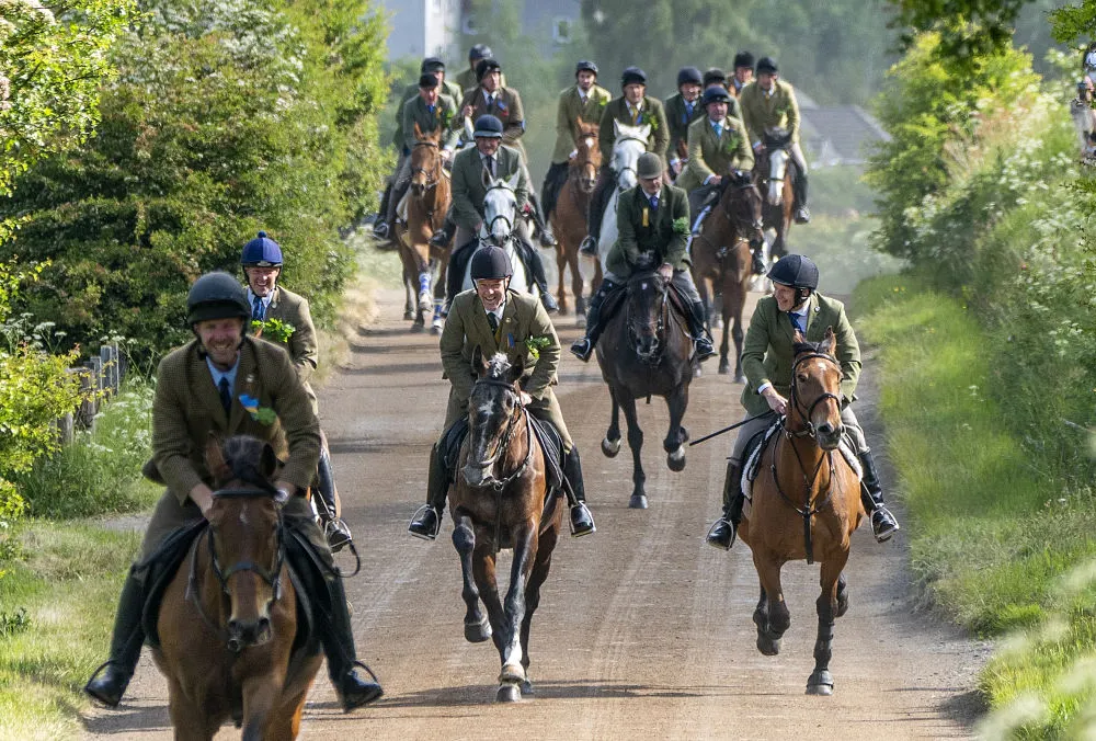 Riders gallop during the Hawick Common Riding in Scotland