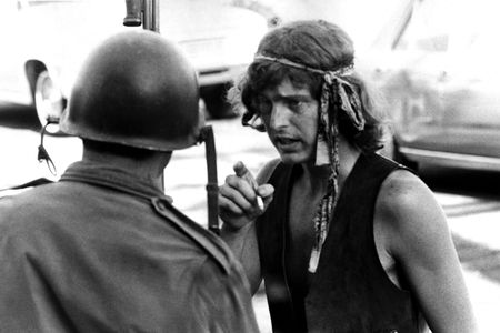 A man smokes a cigarette as he talks to an armored guard at a protest in People’s Park circa May, 1969, in Berkeley, California.