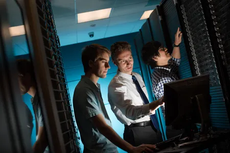 Professor Greg Odegard (center) works with students on the Michigan Tech SUPERIOR computer cluster, to be used to simulate carbon nanotube materials.