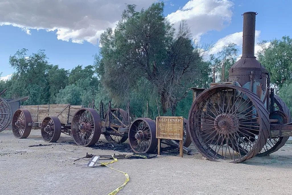 Burned wagon next to steam engine