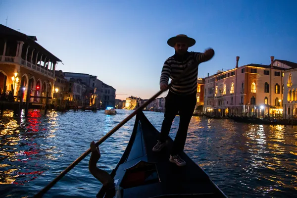 A Gondolier Paddles in the Venetian Canals at Twilight thumbnail