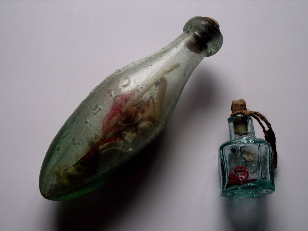 large antique glass bottle with light green liquid as medicine and