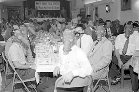 Angelenos wearing smog masks at a banquet, circa 1954.