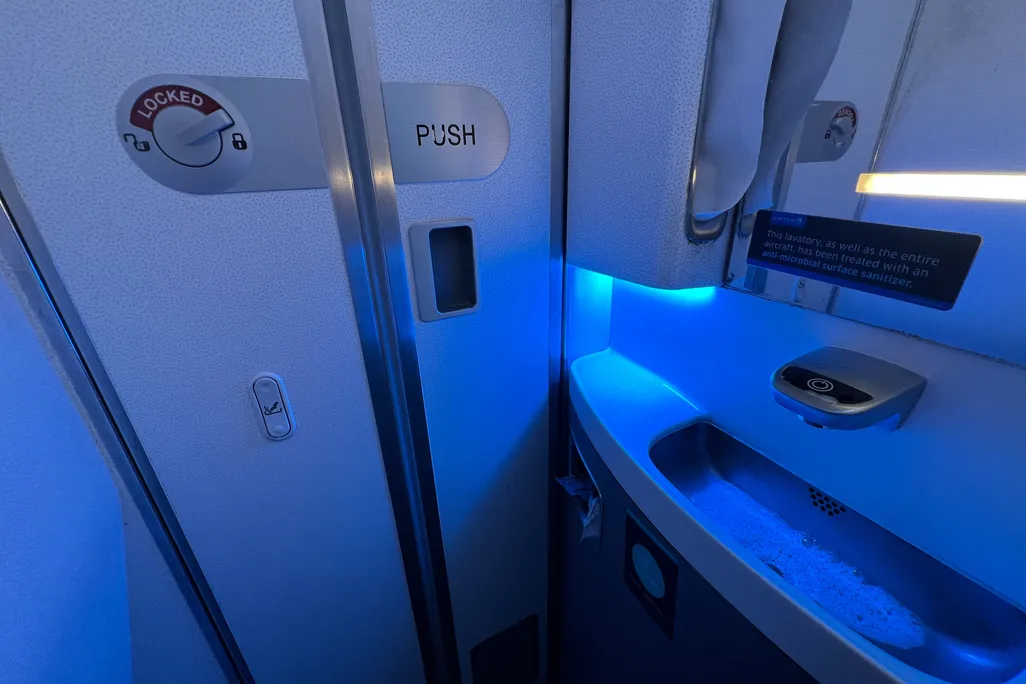 Blue light glowing inside airplane lavatories