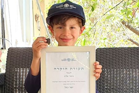 Six-year-old Imri Elya was awarded a "good citizenship" certificate for discovering a rare, small Canaanite tablet near an Israeli archaeological site. 