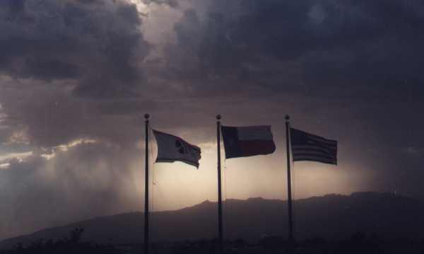Elpaso tx storm as viewed from hotel balcony with flags blowing thumbnail