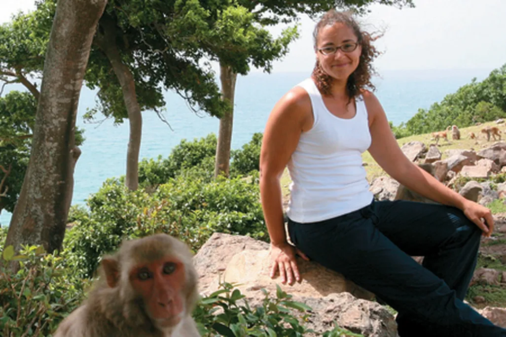 biologist Laurie Santos (with a research subject on Cayo Santiago)