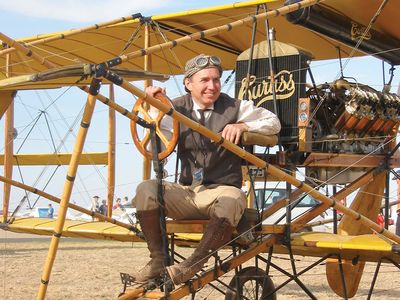 Dan Taylor dresses to suit a Curtiss Model D built by the late Cole Palen, curator of the Old Rhinebeck Aerodrome.