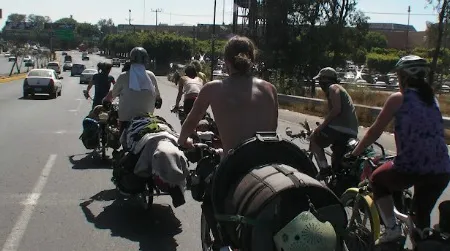 The Ginger Ninjas on the move in Guadalajara, Mexico. Where buses and airplanes would provide the horsepower for other touring bands, the Ginger Ninjas go by bicycle.