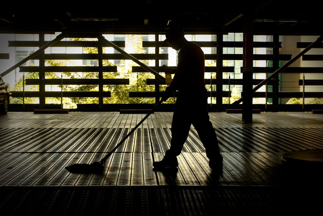 A janitor is mapping some part of the parking area. Smithsonian Photo