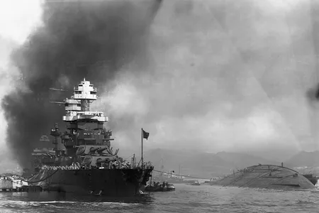 The capsized hull of the U.S.S.&nbsp;Oklahoma&nbsp;(right) is visible next to the U.S.S.&nbsp;Maryland.