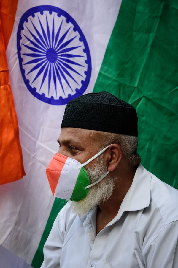 A man with mask painted with Indian flag's tricolor thumbnail
