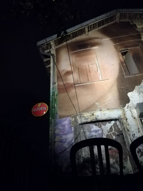 Painted face on a house at night thumbnail