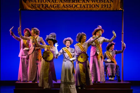 Jenn Colella as Carrie Chapman Catt (center) in&nbsp;Suffs, a new Broadway musical about the women&#39;s suffrage movement